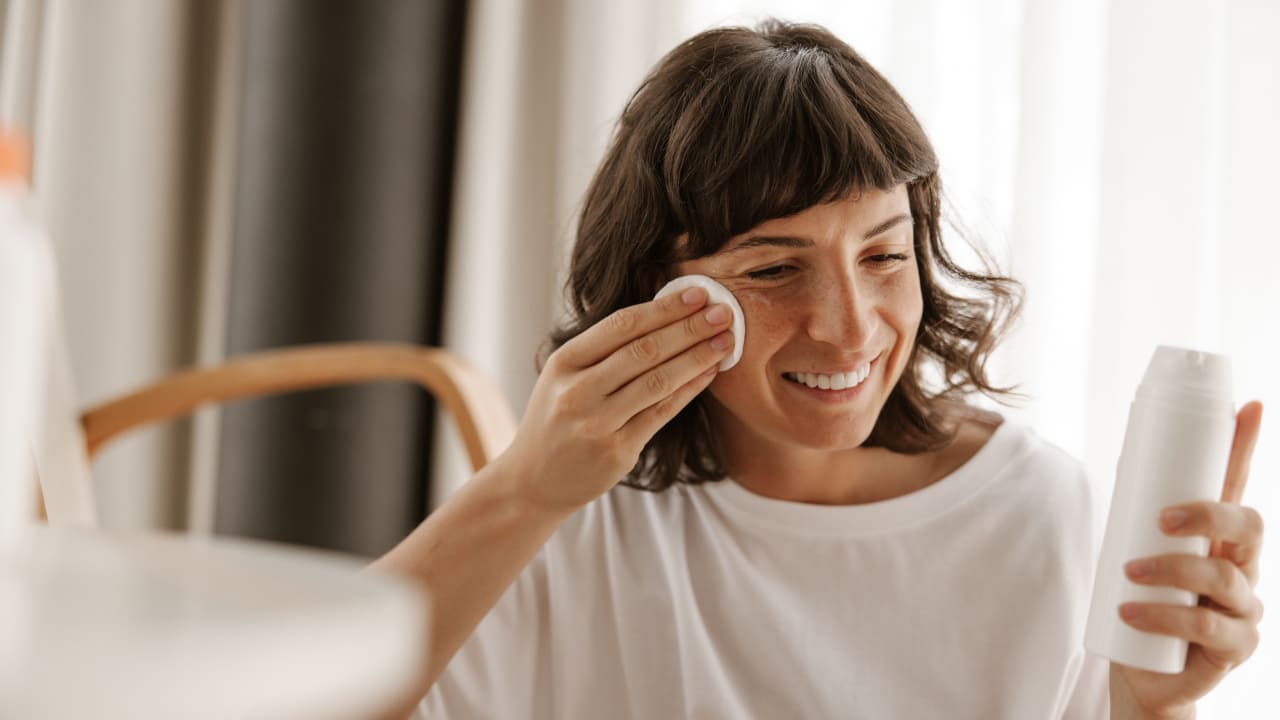 a women removing makeup with cotton pads