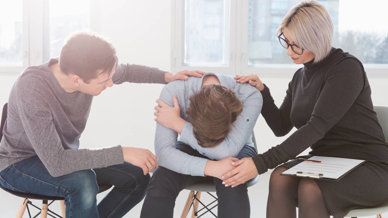 man and women trying to console the boy to cope with the ghosting process