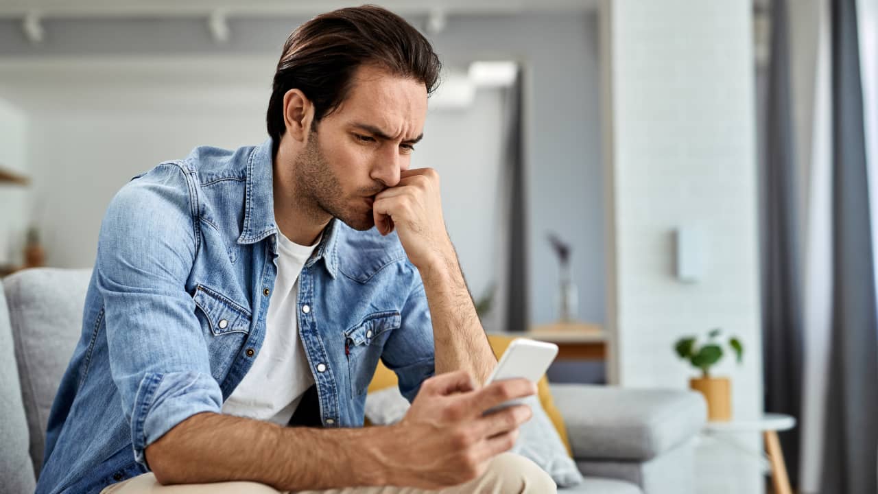 a young man sitting on the sofa, worried about being ghosted